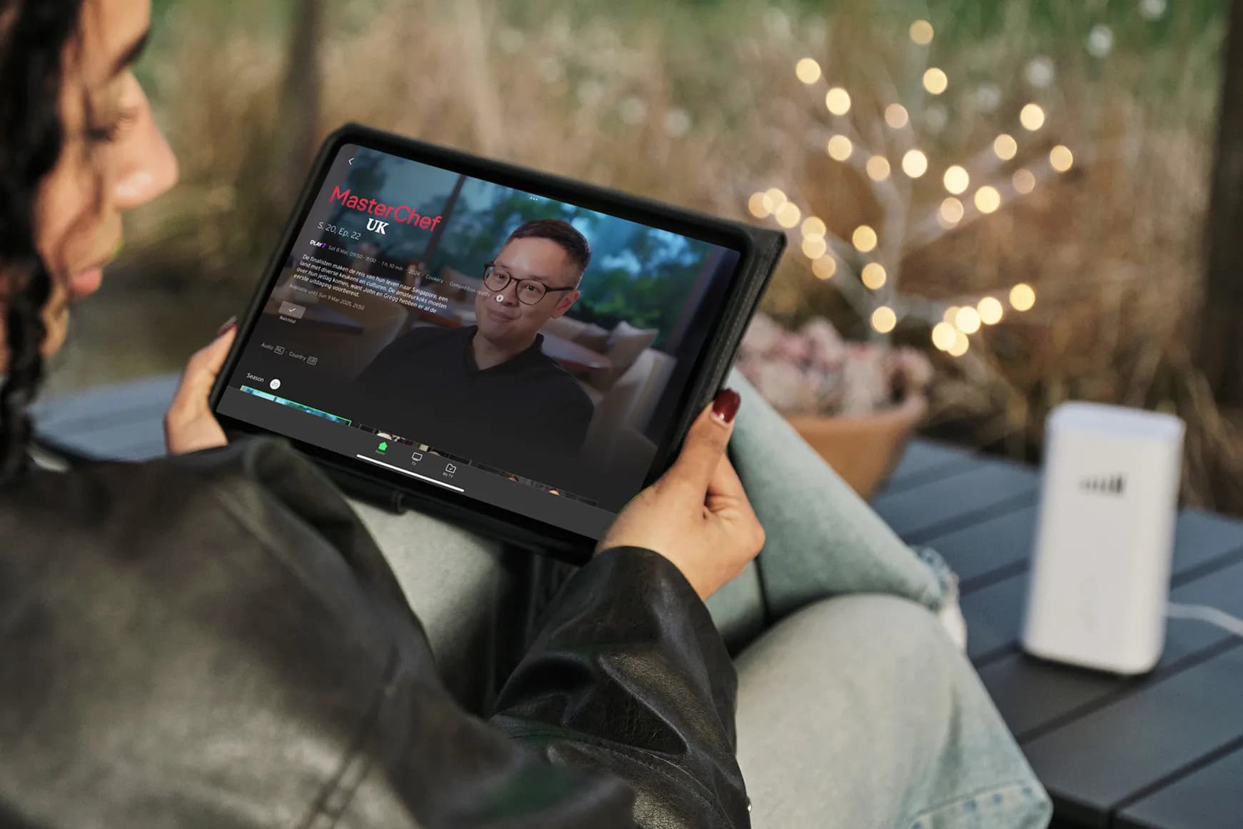 A person watching TADAAM TV on an iPad.